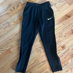 Boys black Nike warm up pants- size small-Has pockets and zips at the ankles